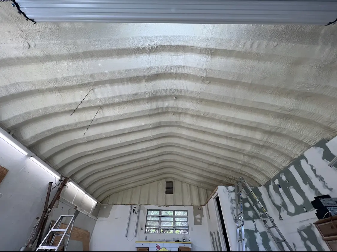 Spray polyurethane foam applied to the underside of a metal roof deck in Verona